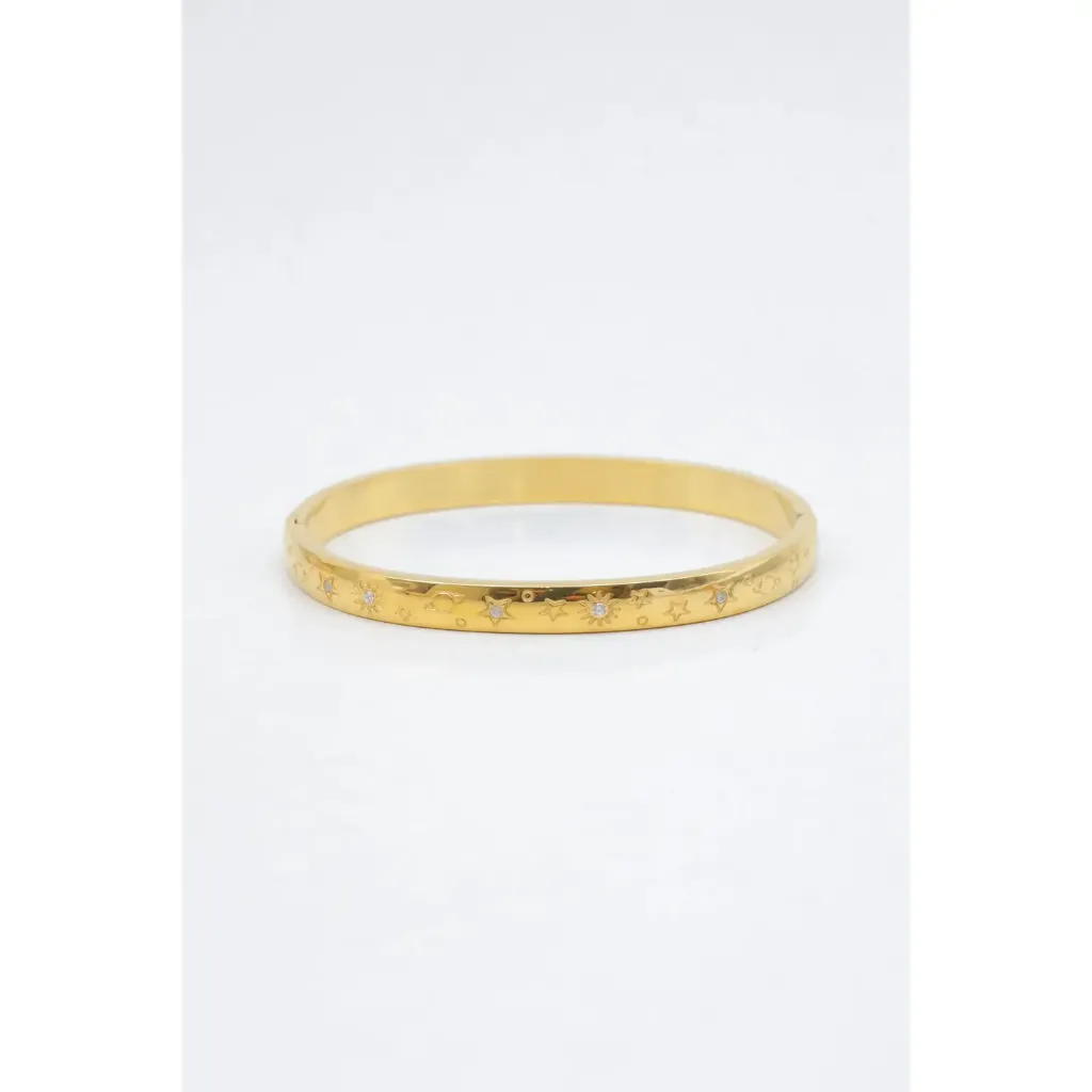 Bracelet jonc céleste gravé doré sur fond blanc.webp